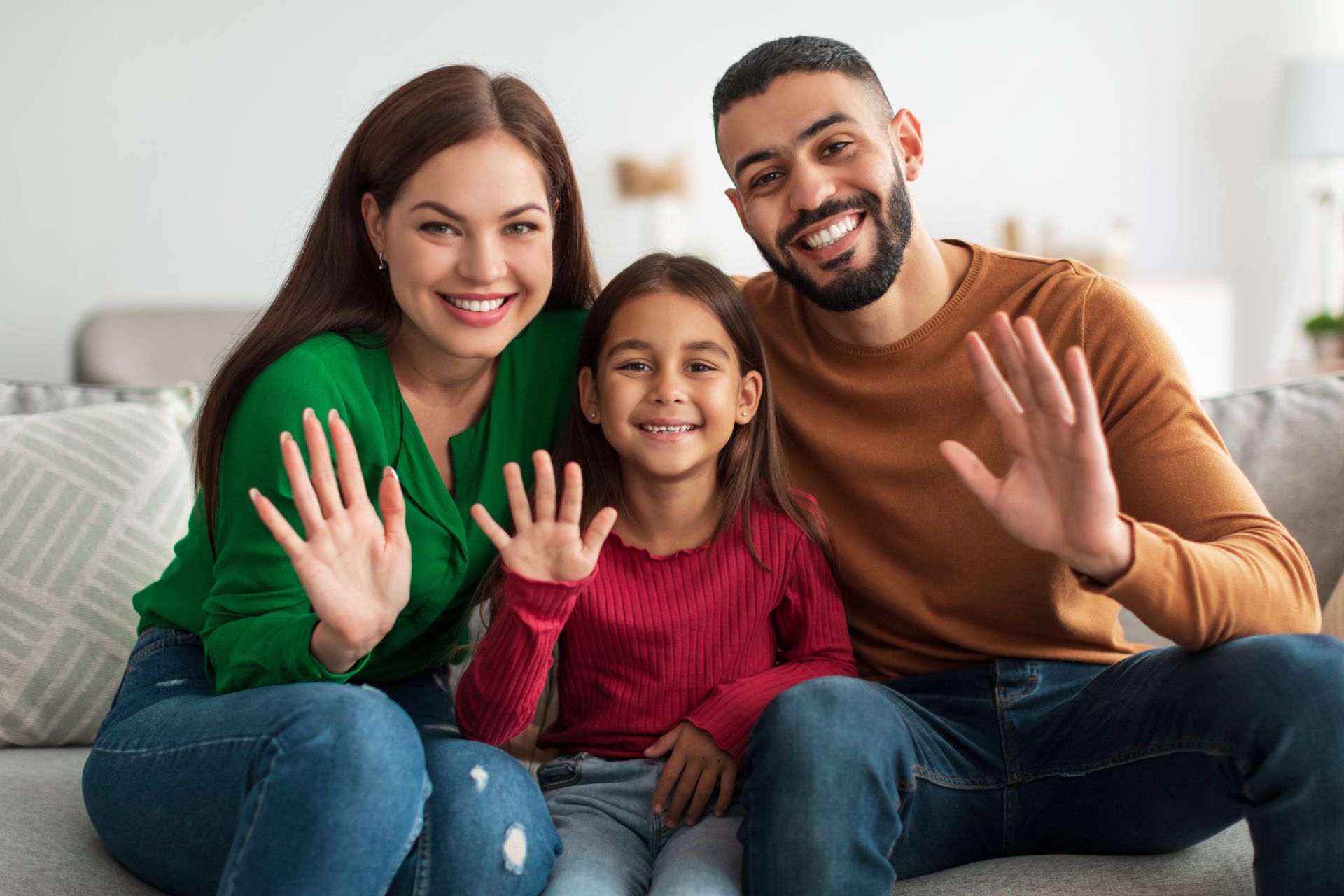 portrait of happy family waving hands at camera jkedwdz.jpg